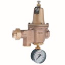 a streamlined brass cast valve body with a dome above it, ports on either end and a pressure gauge below